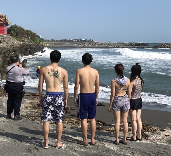 多名大學生旗津海域戲水，2男大生體力不支險溺獲救，其他同學在岸邊等候警、消救人。（記者黃良傑翻攝）
