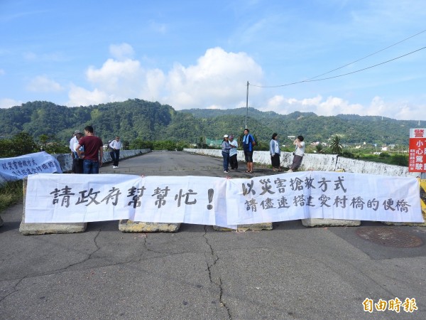 埔里愛村橋周邊4里里民今前往愛村橋掛白布條，盼以災害搶救方式儘速搭建便橋。（記者佟振國攝）