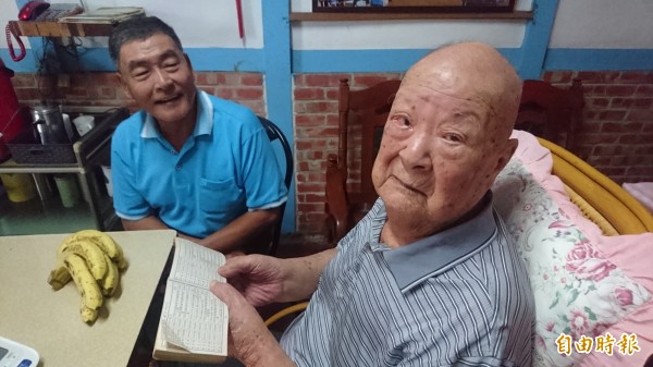 106歲人瑞劉榮珍（右）耳聰目明，看很小的字也沒問題。（記者楊金城攝）