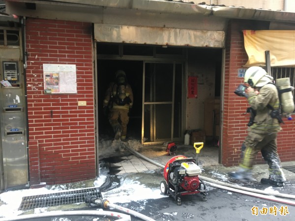 消防隊員將火勢撲滅,救出老婦人。(記者吳昇儒攝)