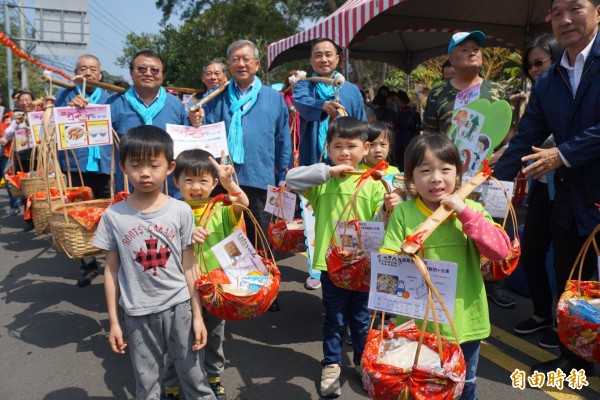 寶山鄉打中午文化季今天元宵節登場，除神明遶境祈福，中午還有挑擔奉飯「食福」，縣長邱鏡淳、鄉長邱坤桶等地方人士和遊客一同挑擔體驗，現場熱鬧滾滾。（記者廖雪茹攝）