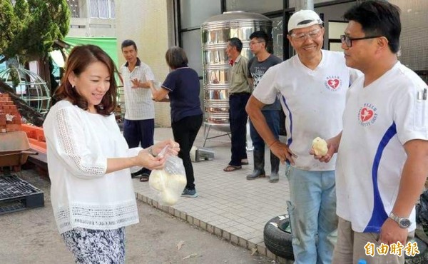 台灣寶島義工行善團志工們在南投縣名間鄉「萬丹巷弄長照站」進行硬體設施改善時，南投縣議員羅美玲（左）送上包子讓志工們當點心吃。（記者謝介裕攝）