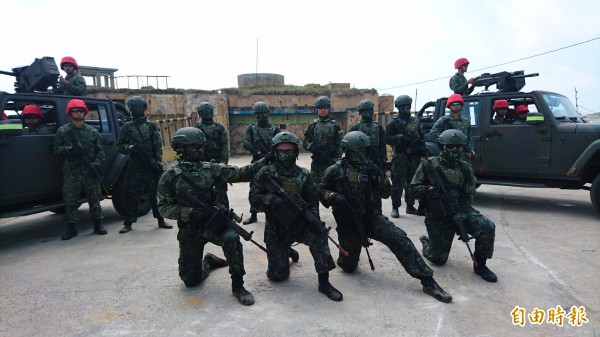 兩棲營官兵在此次演練中分飾攻擊軍與防衛軍角色。中間為擔任特攻角色的攻擊軍(藍軍),左右兩側頭戴紅帽的官兵則擔任防衛軍(紅軍)。(記者羅添斌攝)