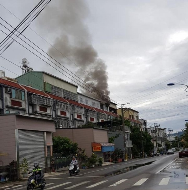 大里公教街一處民宅神明廳今天凌晨起火，遠遠就可看到濃煙竄出。（記者陳建志翻攝臉書《大里人聊天室》）