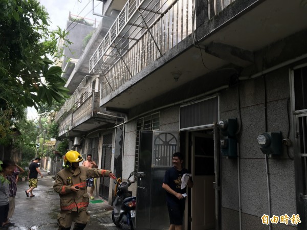 屋主要在回到屋內,消防隊帶隊官擔心他發生危險,請他在門外稍後(記者吳昇儒攝)