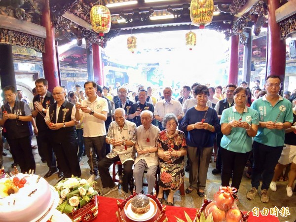 嘉義縣新港奉天宮今天舉辦「開台媽祖契子女，中秋回宮大團圓」活動，廟方邀目前最老的契子女、百歲人瑞林福來（前排左5）祈求平安。（記者曾迺強攝）