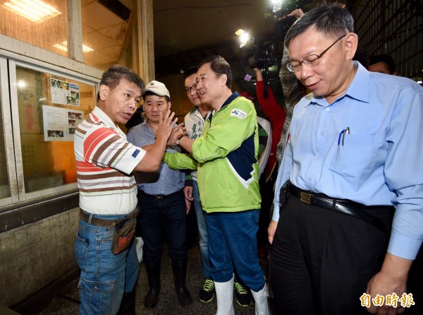 有名攤商嗆柯文哲(右):「你這樣下去的話,我們生意都完蛋了阿!」,副市長陳景峻(綠上衣者)隨即緩頰。(記者羅沛德攝)