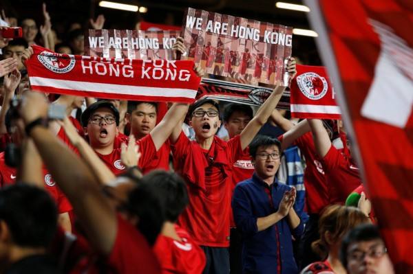 香港球迷在球賽高舉標語表達政治立場。（路透）