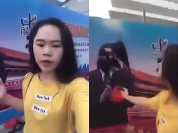 中國女網友「feefeefly」4日清晨6時左右,在上海海航大廈前表示,反對中共獨裁專制暴政,並直播向中國國家主席習近平的宣傳畫像潑墨的過程。(圖擷取自推特)