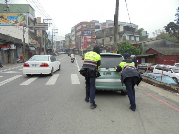 警方熱心幫推拋錨卡在橋上的轎車。（記者李容萍翻攝）