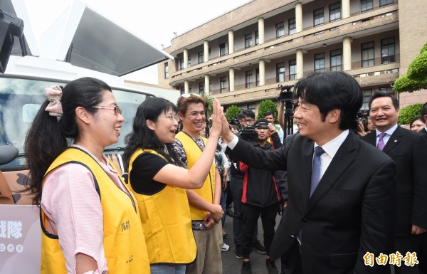 賴清德院長聽取工作人員簡報,同時與工作人員擊掌鼓勵。(記者劉信德攝)