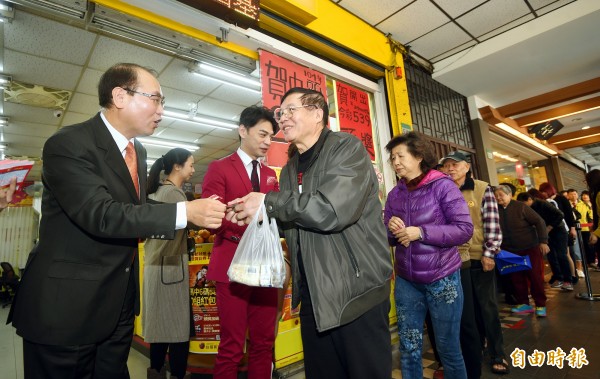 台彩總經理蔡國基與代言人阿ken發紅包。（記者方賓照攝）