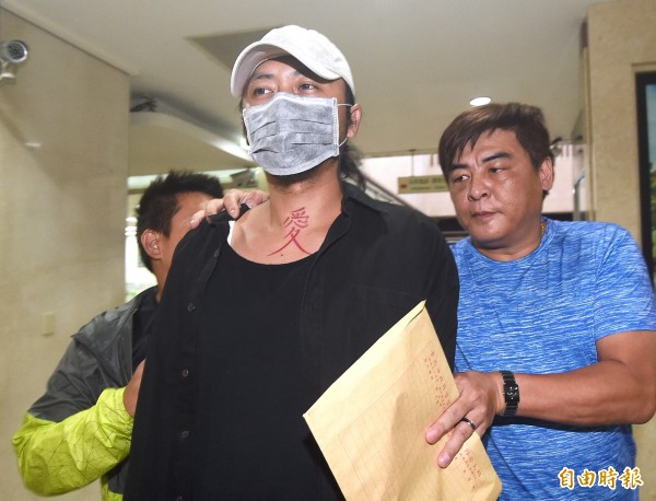 攝影師「穆川申」(前)涉收錢辦性愛趴,北檢10日指揮北市刑大剛搜索約談,警方傍晚將穆移送北檢偵訊。(記者廖振輝攝)