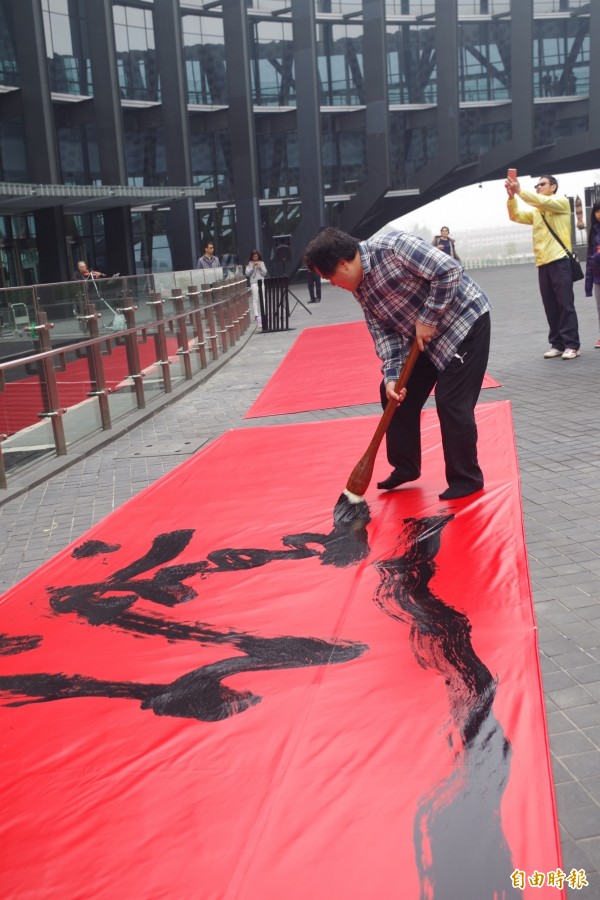 書法家陳世憲運筆流暢,寫下故宮迎燈會等字。(記者王善嬿攝)