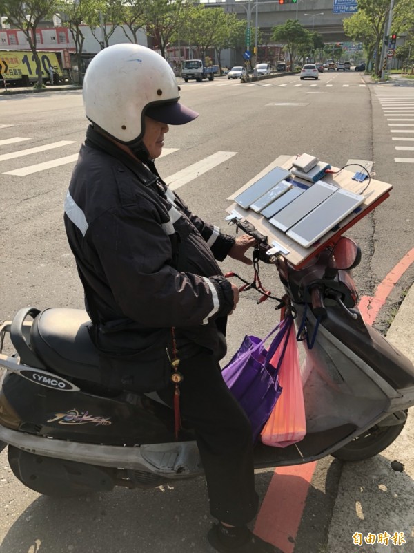 超級寶可夢迷莊姓男子在自己的機車上架設板子,一次擺放5支平板和行動電話,穿梭在大街小巷,方便抓寶、打道館,被封為「寶迷機車一哥」!(記者廖雪茹攝)