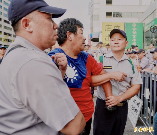 退役軍官繆德生等人，在世大運閉幕式當天前往台北小巨蛋旁的南京東路、北寧路口揮國旗抗議，遭警方驅離。（資料照，記者黃耀徵攝）