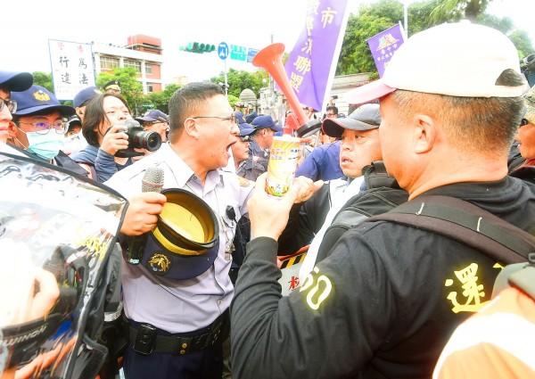 A police officer argues with pension reform protesters yesterday on Ketagalan Boulevard near the Presidential Office Building in Taipei.
Photo: Fang Pin-chao, Taipei Times A police officer argues with pension reform protesters yesterday on Ketagalan Boulevard near the Presidential Office Building in Taipei.
Photo: Fang Pin-chao, Taipei Times