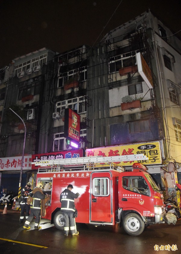 新北市中和一棟公寓出租套房22日晚間發生火警釀9死2傷,公寓被濃煙薰黑。(記者黃耀徵攝)
