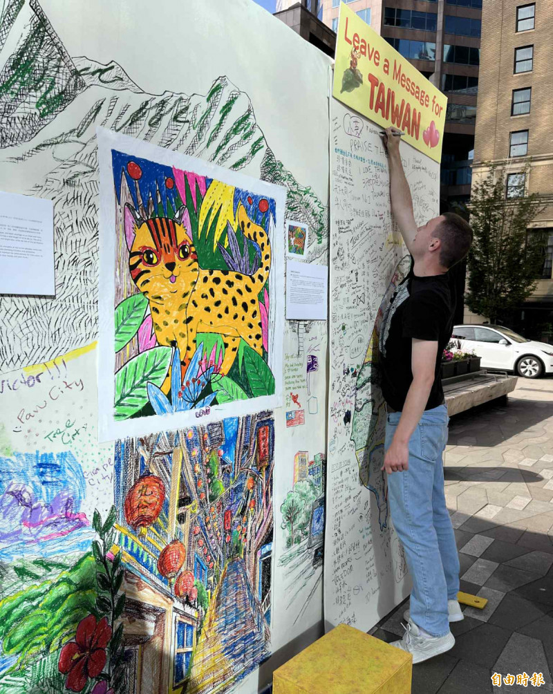 一名男士正在寫台灣留言板。（記者張伶銖攝）