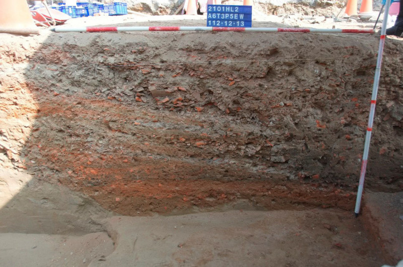 分層夯實的道路剖面，可看見密集的糖漏破片。（南市文資處提供）