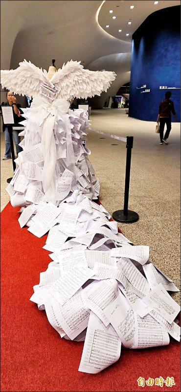 以千張樂譜層層堆疊縫製的長襬禮服，綻放的羽翼象徵80年來台灣之聲飛向世界。（記者凌美雪攝）