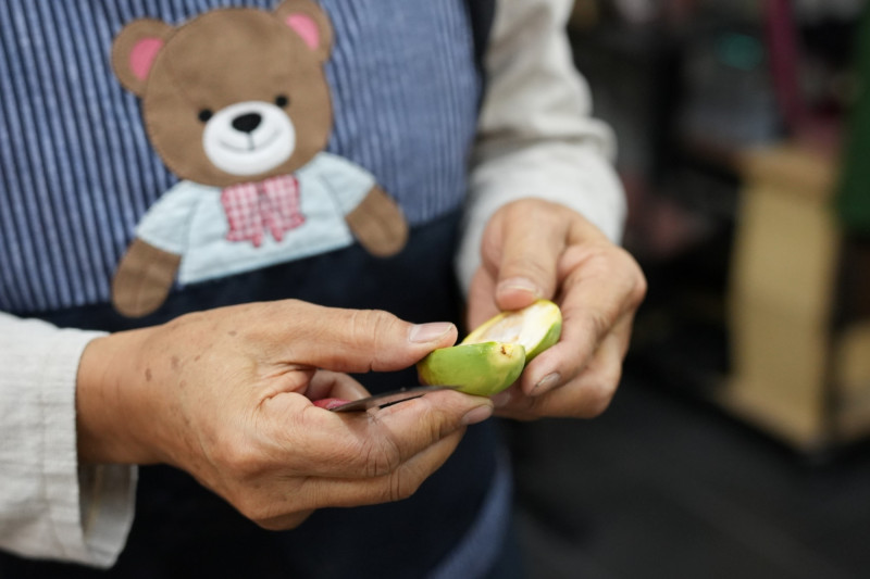 工藝師陳毓芳熟練剖開檳榔子。（屏東縣政府提供）