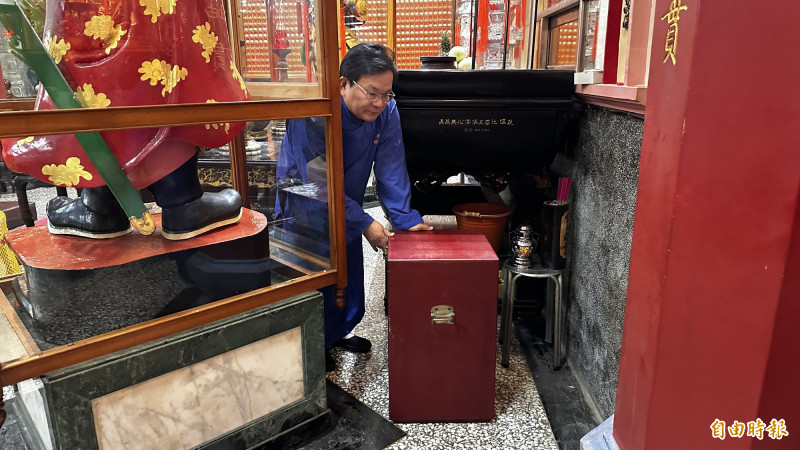 廟方人員將裝有安太歲民眾頭髮、指甲及相關資料的紅包袋，放置在值年太歲星君座下「掩運」。（記者劉婉君攝）