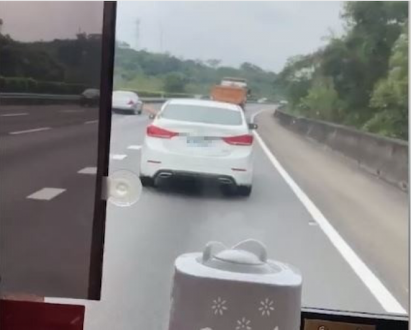 白車駕駛國道上危險逼車，甚至伸手比出不雅手勢嗆聲。（記者鄭名翔翻攝）
