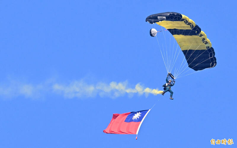 國防部今天在陸軍空訓中心展現傘兵實地跳傘訓練戰力，神龍小組人員以高超跳傘特技技巧，呈現高空滲透丶三人疊傘等高難度技巧，獲得全場讚歎喝采。（記者廖振輝攝）