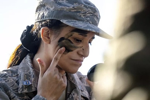 美國陸軍計畫對戰鬥職位男女採相同體測標準，預計將對女性士兵帶來嚴峻挑戰。圖為一名高中JROTC（預備軍官訓練團）學員在陸軍活動中塗抹迷彩，準備迎接可能的軍旅生涯。（美聯社）