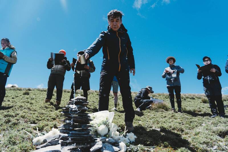 特遣隊員在三叉山頂舉行莊嚴的祈禱儀式，獻花、獻酒並堆砌石塔祈願，以虔敬行動向罹難者致上最高敬意。（軍聞社提供）