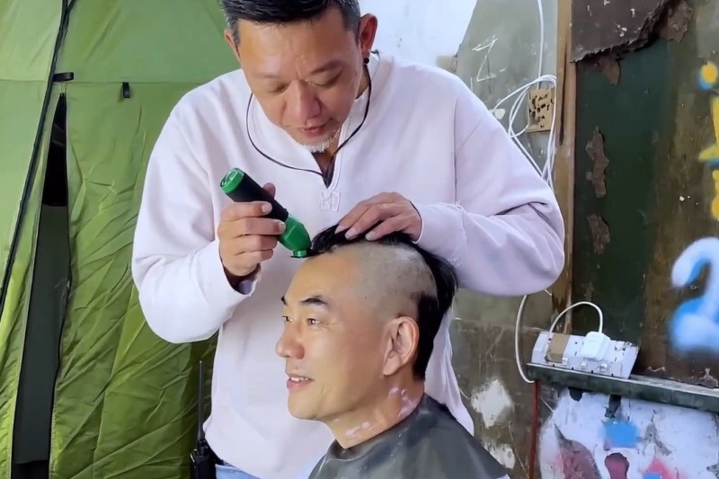 任賢齊（前）讓《九龍城寨之圍城》導演鄭保瑞剃頭。（翻攝任賢齊臉書）