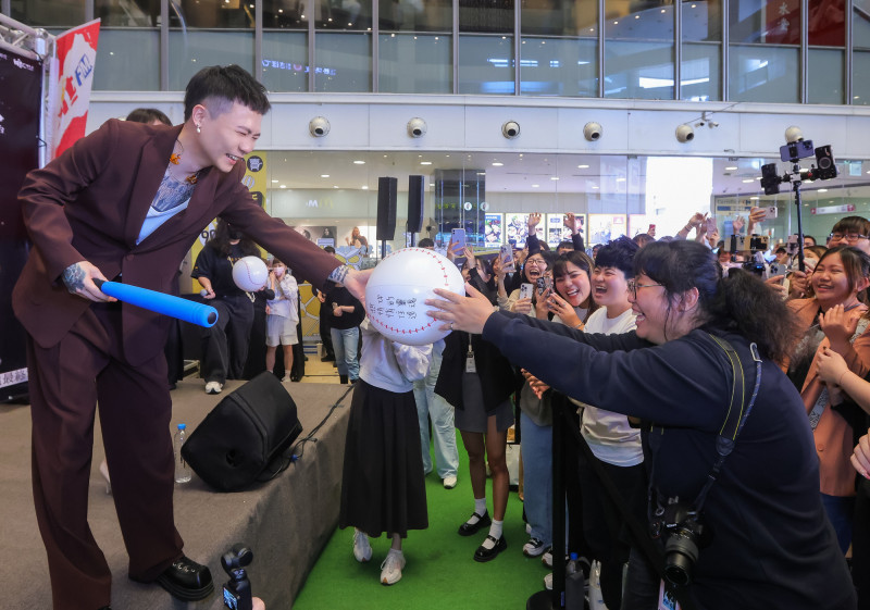 蕭秉治(左)在台中簽唱會和歌迷玩揮棒互動遊戲。(相信音樂提供)