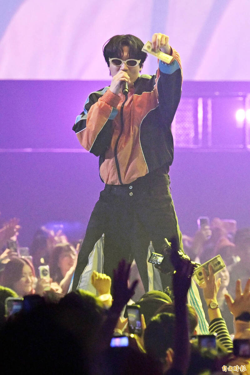 宇宙人小玉唱歌撒下玩具「鈔票」。（記者胡舜翔攝）