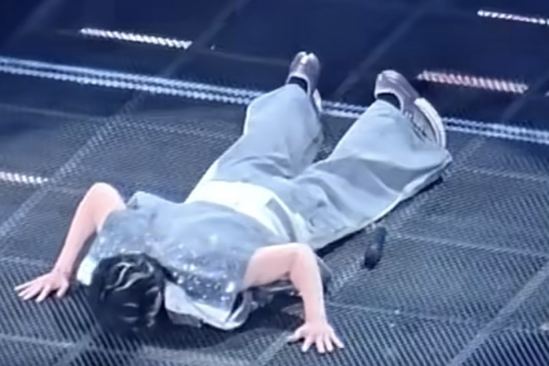 王力宏因項鍊卡進金屬網格地板縫隙，短暫受困舞台。（翻攝自微博）