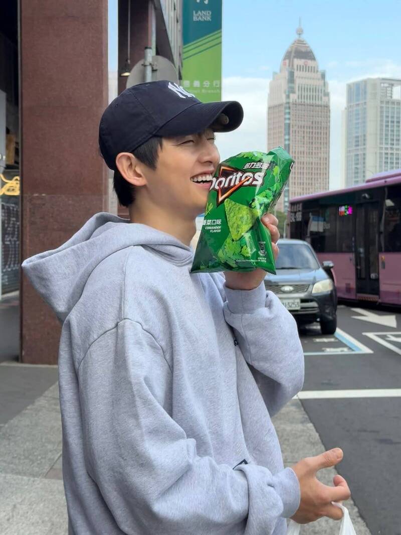 宋仲基拿著香菜口味零食笑得超開心。（翻攝自IG）