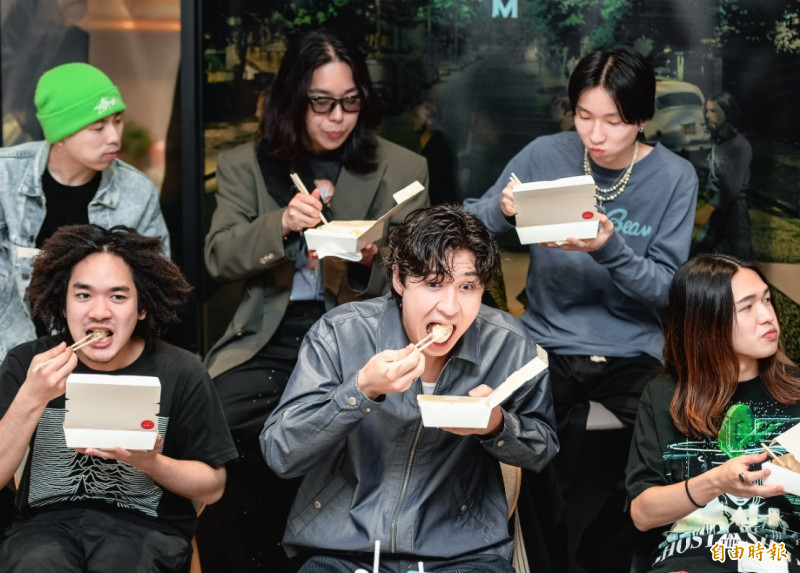 Billyrrom剛下機就飛奔受訪，鼓手Shunsuke（前排左起）、主唱Mol、鍵盤與合成器手Leno，吉他手Rin（後排左起）、DJ Yuta Hara、貝斯手Taisei watabiki吃小籠包，大快朵頤。（記者王文麟攝）