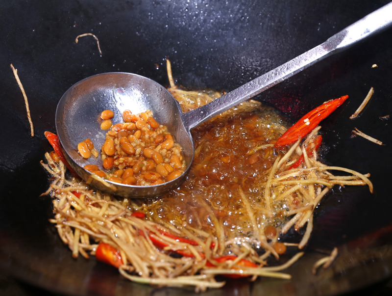 用餘油炒薑絲與辣椒，油滾後倒進黃豆醬與糖，再加一碗水，滾後放竹筍、轉中火，燜5∼10分鐘，最後加肉絲，煮至肉絲變熟即可。