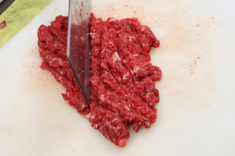 將牛肉剁碎，加入約1／2碗量的水，接著加入鹽、白糖、黑胡椒粉、醬油、太白粉，攪拌至有黏性。