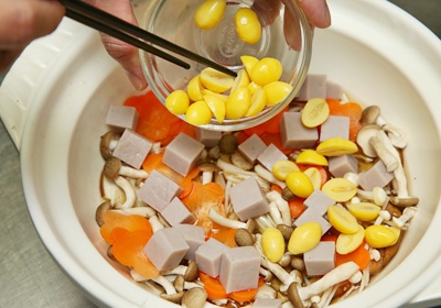 先將炊飯高湯食材拌勻。將米放進陶鍋中，依序放入香菇片、鴻禧菇、金針菇、芋頭丁、紅蘿蔔片、銀杏、毛豆仁，再倒入炊飯高湯。