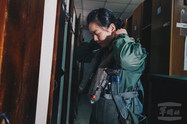 中尉郭文靜在個裝室穿戴個人裝備，包含抗G衣，適身套袋以及救生背心。（圖：軍聞社提供）
