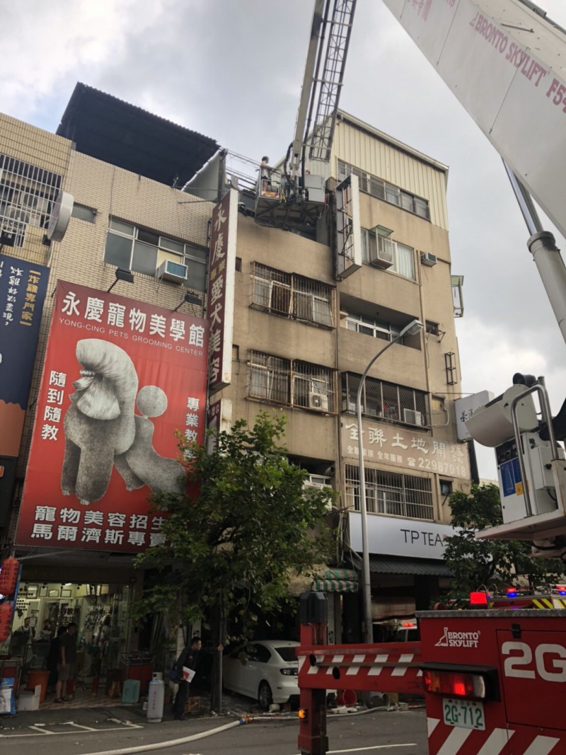 消防人員出動雲梯車將受困店內3人救下。（台中市消防局提供）