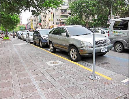 民眾投訴，台北市部分市議員候選人競選總部前方的收費停車位遭到取消，還塗上黃線。此路段僅有一小段黃線，十分明顯。（記者林相美攝）