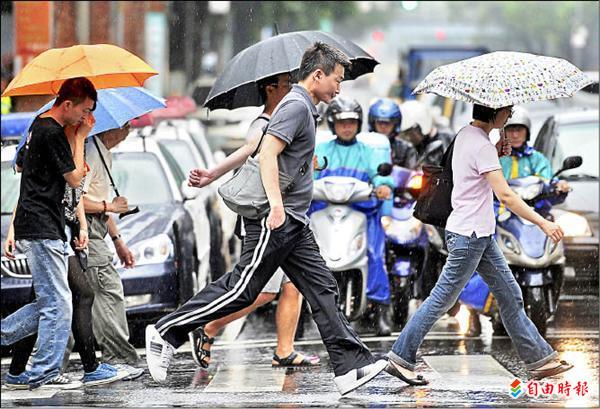 台北市昨天午後下起一場大雷雨，沒有攜帶雨具的民眾趁雨勢稍歇快跑通過路口。（記者廖振輝攝）