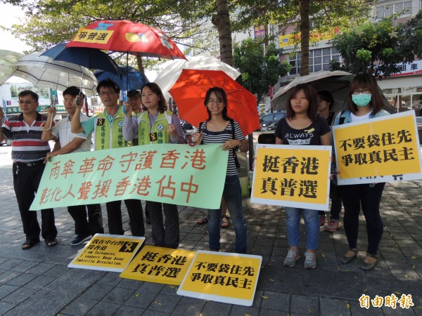 香港雨傘革命爭真普選，彰化多個團體今天在彰化火車站持傘相挺。（記者吳為恭攝）