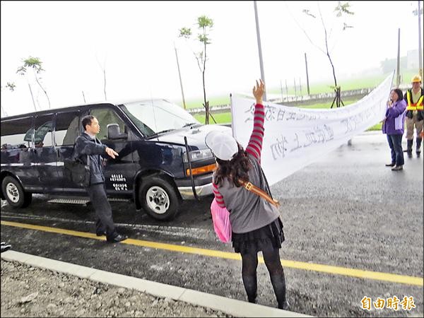 自救會成員拉白布條，試圖阻撓交通部長陳建宇的座車離開。（記者王揚宇攝）