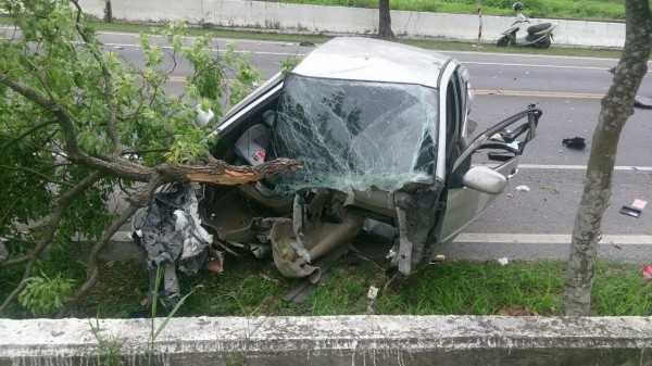 行經彎路未減速，自小客車衝撞路樹，應聲解體，駕駛慘死。（記者陳賢義翻攝）