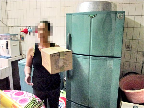 婦人把死胎從冰箱取出，交給葬儀社。（警方提供）
