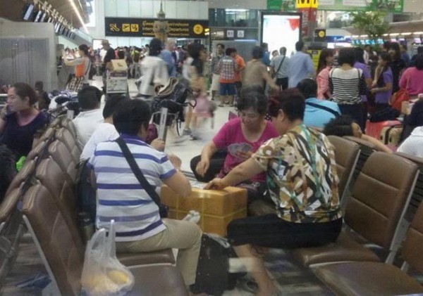 泰國充斥中國遊客，圖為中客在泰國機場打牌，引人詬病。（圖擷取自網路）