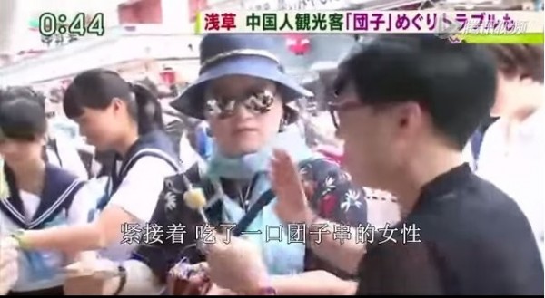 日本電視節目探討中國遊客亂象，目擊2名中國大媽在糯米團丸子串攤位前吃了一口又揮手說「不要了」，讓店家傻眼。（圖擷自影片） 